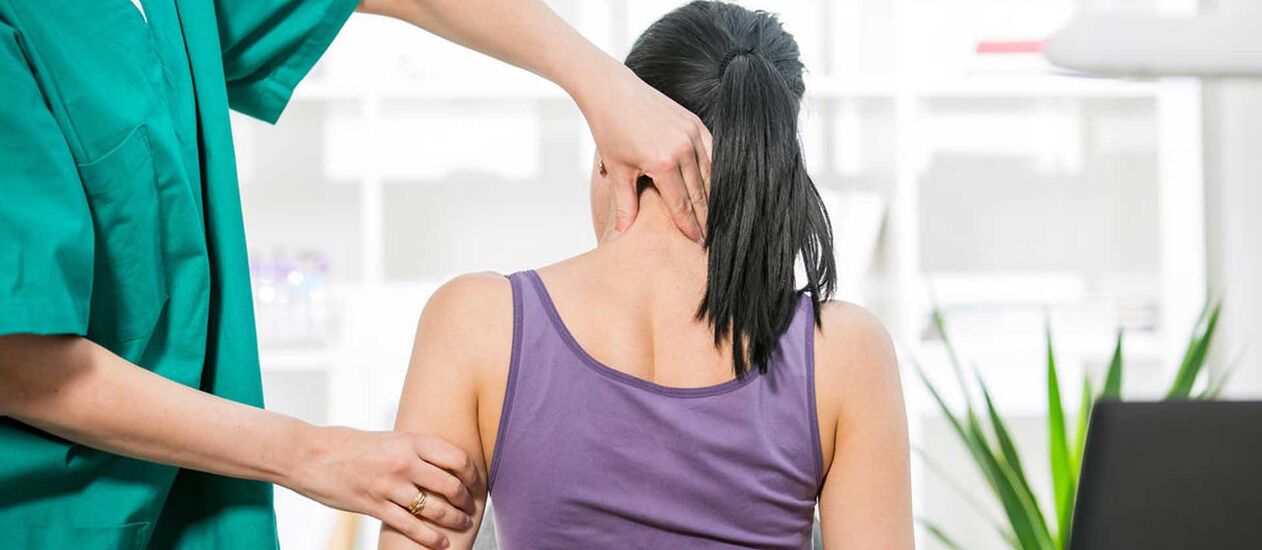 Patient with neck pain being examined by a doctor