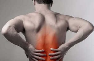 a man holding a sore spot on the back